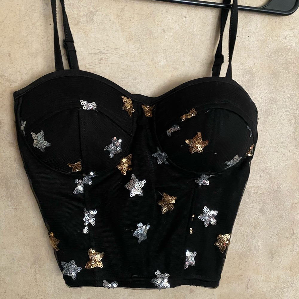 Black top with star detail. Size M
